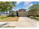 Charming home featuring a two-car garage, well-manicured lawn, and inviting curb appeal at 13188 Royal Pines Ave, Riverview, FL 33579