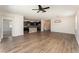 Open-concept living room connected to a modern kitchen, featuring hardwood floors at 13188 Royal Pines Ave, Riverview, FL 33579