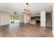 Bright living area with hardwood floors, connecting seamlessly to the modern kitchen and backyard patio at 13188 Royal Pines Ave, Riverview, FL 33579
