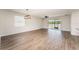 Spacious living room featuring hardwood floors and natural light with views to the backyard at 13188 Royal Pines Ave, Riverview, FL 33579