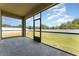 Enclosed screened porch with views of the fenced-in backyard and plenty of natural light at 13188 Royal Pines Ave, Riverview, FL 33579
