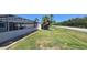 Wide shot of backyard with pool enclosure and chain link fence at 3309 Rock Valley Dr, Holiday, FL 34691