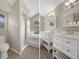 Bathroom featuring shower, toilet, tub, double sinks, and arched window at 621 Erin Way, Brooksville, FL 34601