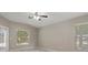 Spacious bedroom with fan and natural light, looking out to a screened-in lanai at 621 Erin Way, Brooksville, FL 34601