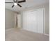 Bedroom features a ceiling fan, carpet floors and a closet that offers ample storage space at 621 Erin Way, Brooksville, FL 34601