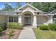 Elegant double front doors with decorative glass and a welcoming walkway at 621 Erin Way, Brooksville, FL 34601