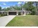 Charming single-story home boasts a well-manicured lawn and inviting curb appeal at 621 Erin Way, Brooksville, FL 34601