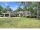 Well-maintained single-story home features lush landscaping and a welcoming entrance at 621 Erin Way, Brooksville, FL 34601