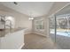 Open kitchen with granite countertops and views of screened in lanai and pool at 621 Erin Way, Brooksville, FL 34601