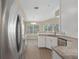 Bright kitchen with granite countertops, stainless steel appliances, and wood flooring at 621 Erin Way, Brooksville, FL 34601
