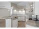 Updated kitchen with a granite countertops, stainless steel appliances, and white cabinets at 621 Erin Way, Brooksville, FL 34601