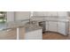 Kitchen island featuring granite countertops, stainless steel dishwasher, and modern white cabinetry at 621 Erin Way, Brooksville, FL 34601