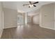 Open living area with hardwood floors, ceiling fan, and views of outdoor space at 621 Erin Way, Brooksville, FL 34601