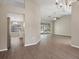 Open living space flows to kitchen and pool, featuring wood floors and neutral tones at 621 Erin Way, Brooksville, FL 34601
