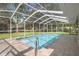 Screened in pool with brick paver deck offers space for outdoor lounging at 621 Erin Way, Brooksville, FL 34601