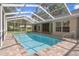 Screened in pool provides privacy and access to the home's interior at 621 Erin Way, Brooksville, FL 34601