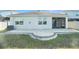 Backyard patio with a screened in porch area, green grass, and a modern AC unit at 2587 Garden Plum Pl, Odessa, FL 33556