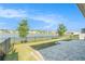 Beautiful backyard with a stunning lake view, patio, black metal fence, and blue skies at 2587 Garden Plum Pl, Odessa, FL 33556