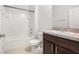 Bathroom with a shower and bathtub combination, white tiling, toilet, and vanity at 2587 Garden Plum Pl, Odessa, FL 33556