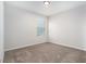 Bright bedroom features neutral carpet and trim with a window offering natural light at 2587 Garden Plum Pl, Odessa, FL 33556