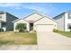 Charming single-story home with a well-manicured lawn and attached two-car garage in a quiet neighborhood at 2587 Garden Plum Pl, Odessa, FL 33556