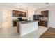 Beautiful kitchen with granite countertops, stainless steel appliances, and a center island at 2587 Garden Plum Pl, Odessa, FL 33556