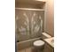 Clean bathroom with decorative glass shower doors, a toilet, and a simple sink vanity at 4152 66Th Street W Cir # 4152, Bradenton, FL 34209