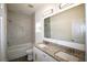 Bright bathroom featuring double sinks, granite countertops, and a tiled shower-tub combo at 8990 Glenarm Way, Weeki Wachee, FL 34613