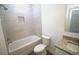 Bathroom boasting a tiled bathtub, shower, shower niche, toilet, and granite sink at 8990 Glenarm Way, Weeki Wachee, FL 34613