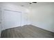 Bright, empty bedroom offers plank floors, ample closet space, and a ceiling fan at 8990 Glenarm Way, Weeki Wachee, FL 34613