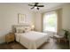 Bright bedroom featuring a ceiling fan, natural light, modern décor, and neutral tones at 8990 Glenarm Way, Weeki Wachee, FL 34613