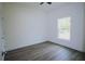 An empty room with great natural lighting and plank flooring at 8990 Glenarm Way, Weeki Wachee, FL 34613