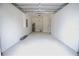 Spacious two car garage with a water heater and an overhead door at 8990 Glenarm Way, Weeki Wachee, FL 34613