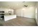 Bright kitchen features stainless steel appliances, granite countertops and plank flooring throughout an open layout at 8990 Glenarm Way, Weeki Wachee, FL 34613