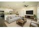 Tastefully furnished living room, adjacent to the kitchen, with stylish furniture and decor at 8990 Glenarm Way, Weeki Wachee, FL 34613