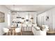 A modern kitchen and open-concept living space with pendant lighting and counter seating, perfect for entertaining at 8990 Glenarm Way, Weeki Wachee, FL 34613