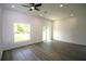 Bright living room featuring sleek flooring, recessed lighting, a fan, a window, and sliding glass doors at 8990 Glenarm Way, Weeki Wachee, FL 34613
