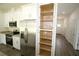 Bright kitchen with white cabinets and a walk-in pantry for ample storage and organization at 8990 Glenarm Way, Weeki Wachee, FL 34613