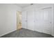 Bedroom featuring an open doorway, double door closet, and neutral carpet at 14118 Crutchfield Ct, Parrish, FL 34219