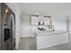 Bright kitchen featuring white cabinetry, stainless steel appliances, and quartz counters at 14118 Crutchfield Ct, Parrish, FL 34219