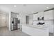 Bright kitchen featuring white cabinetry, stainless steel appliances, and quartz counters at 14118 Crutchfield Ct, Parrish, FL 34219