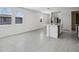Spacious living and dining area with modern gray tile flooring, stainless steel appliances, and bright white walls at 14118 Crutchfield Ct, Parrish, FL 34219