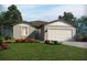 Charming single-story home with a two-car garage, landscaped front yard, and neutral-toned exterior at 160 Lazy Shore Dr, Nokomis, FL 34275