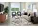 Cozy living room featuring stylish furniture, a large window, and a serene view of the outdoors at 160 Lazy Shore Dr, Nokomis, FL 34275