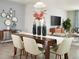 Elegant dining room with a dark wood table, six chairs, and modern decor at 193 Lazy Shore Dr, Nokomis, FL 34275