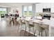 Bright, open-concept kitchen with a large island, modern appliances, and an adjacent living area at 193 Lazy Shore Dr, Nokomis, FL 34275