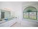 Bright bathroom with double sinks, stained glass window, and separate shower and soaking tub at 470 Bermuda Isles Cir, Venice, FL 34292