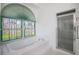 Bright bathroom with stained glass window, shower and soaking tub at 470 Bermuda Isles Cir, Venice, FL 34292
