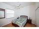 Bright bedroom with ceiling fan, closet, and hardwood floors at 470 Bermuda Isles Cir, Venice, FL 34292