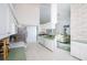 Bright kitchen featuring white cabinetry, green countertops, and an open layout to the living room at 470 Bermuda Isles Cir, Venice, FL 34292